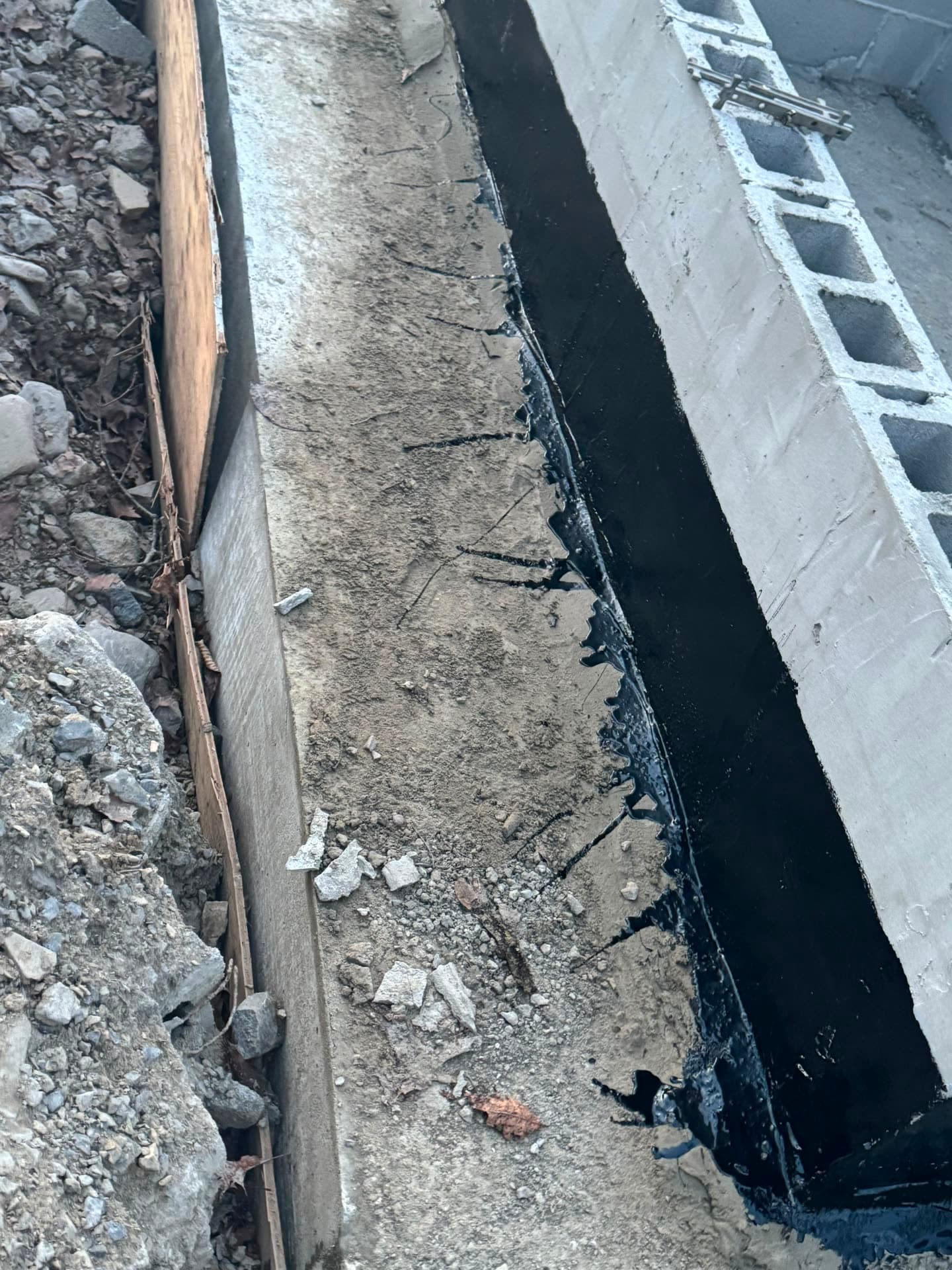 Excavated foundation with wooden concrete forms set on a New Jersey job site under clear skies