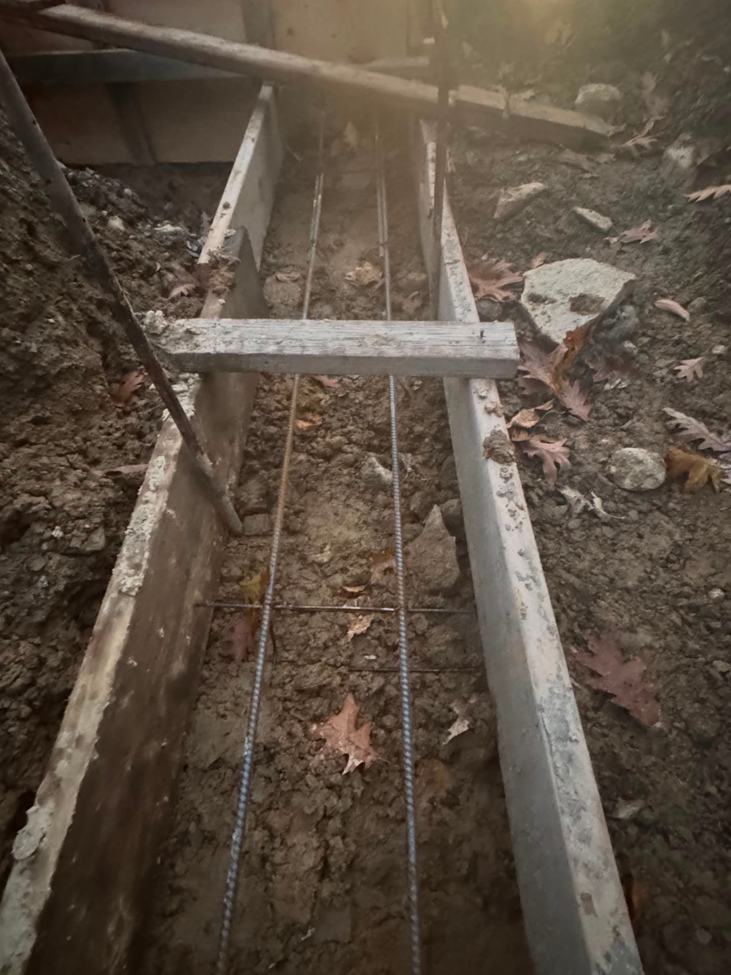 Freshly installed concrete driveway and curb section in front of a New Jersey home